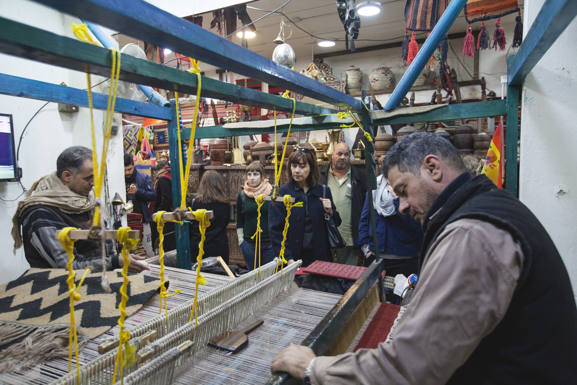 Demonstrating work on the traditional loom at Essa Farrah’s store